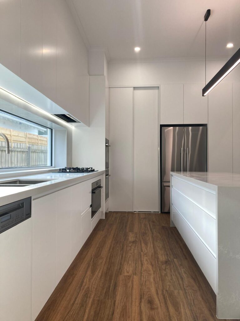 Modern white kitchen renovation in Coogee with custom cabinetry by Sabra Projects